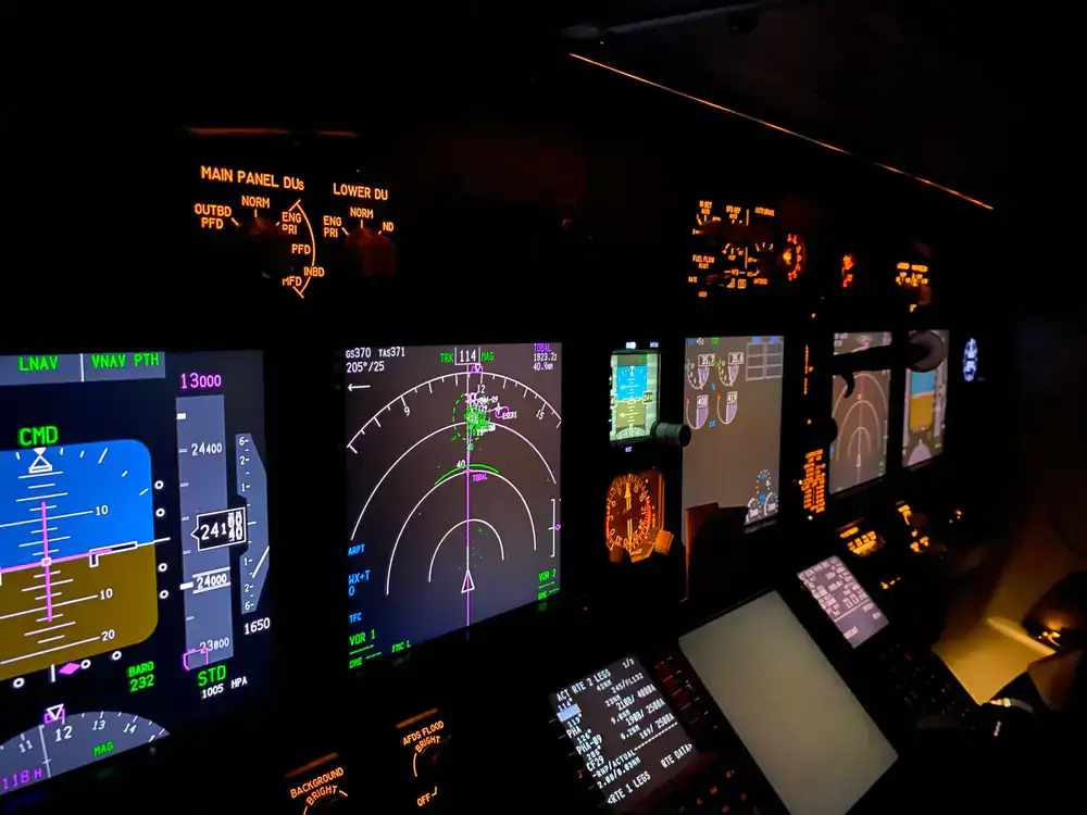 Student navigating a virtual flight route on a dual-monitor setup