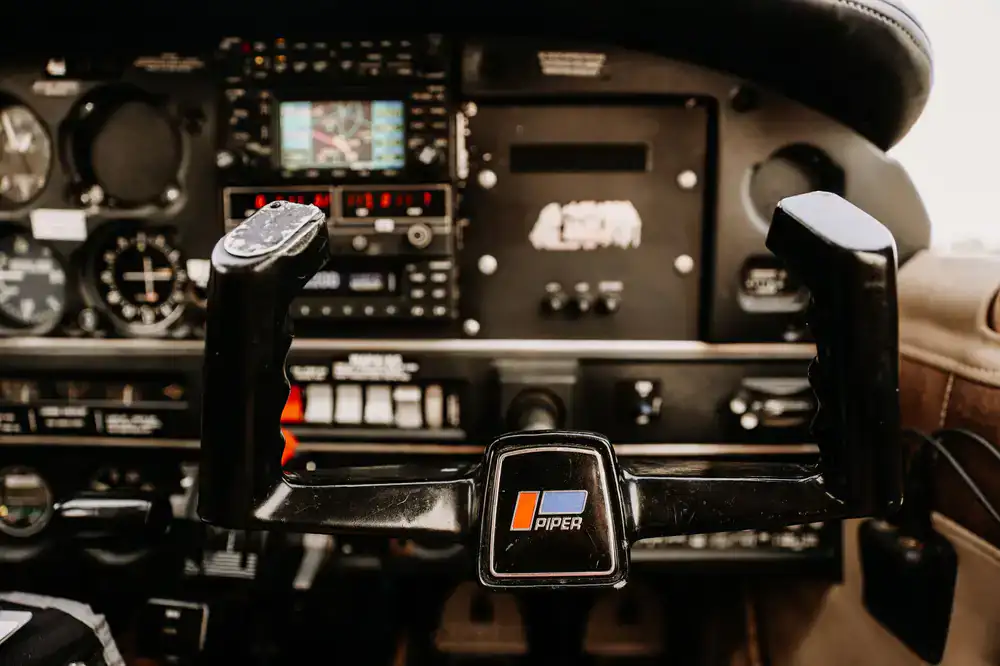 Detailed view of flight simulator yoke and throttle quadrant